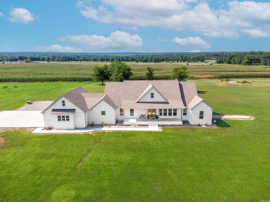 Take a look at this beautiful house on 3 acres in Vilonia School District! Not even two years old and only 10 minutes to the heart of conway, this house boasts SO many custom features. Check out this beautiful county setting! Walk through the stunning 8 foot mahogany front doors to your dream home! You will find beautiful vaulted ceilings with accent beams, stained floating shelves, oversized kitchen island perfect for entertaining, soft close cabinets throughout, walk in pantry and a 48" Forno gas stove range. This open floor plan has a spacious laundry room with a dog washing station, custom master bathroom with walk in shower, double shower heads and tub as well as built in dresser and shelves in master closet. Four bedrooms, 2.5 baths with the fourth bedroom used as a flex space/gym that can easily be turned into another bedroom. Walk outside to the spacious covered front and back porches with stained wood ceilings. Propane connect available for grilling and enjoying entertainment outdoors. French drains installed throughout the property, tankless water heater and fully insulated garage with a SAFE ROOM. Schedule your showing today!!