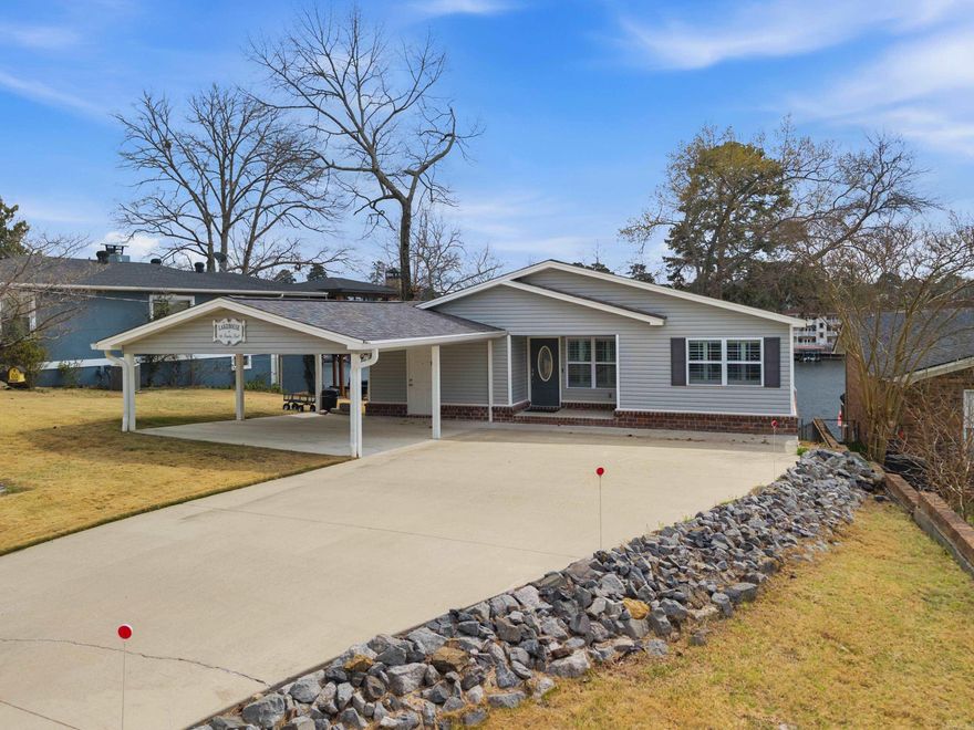 Easy Lake Living!  This newly remodeled 2600 Sq. Ft. 3 Bedroom 3 Bath home is the perfect place to relax, unwind and enjoy all the pleasures of lake life on beautiful Lake Hamilton.  This home features a fabulous open floor plan with great lake views from both the brand new kitchen and the spacious family room that features a stone gas log fireplace and access to the deck overlooking the fenced backyard and the lake.  There are 2 spacious bedrooms, a bunk room and small office on the main floor.  The main suite has an en suite bath and access to the backyard.  Downstairs you'll find another bedroom or living area as well as the third bath, laundry room and the second kitchen.  Outside entertaining is easy with both the upper deck and lower level patio.  Down by the lake there is a spacious area with a firepit and seating area.  There is a single stall boat dock with lift, a jet ski dock and a swim dock on year round water.  This home is selling with furniture and includes all appliances and tvs.  See a list of items that do not convey in agent remarks.