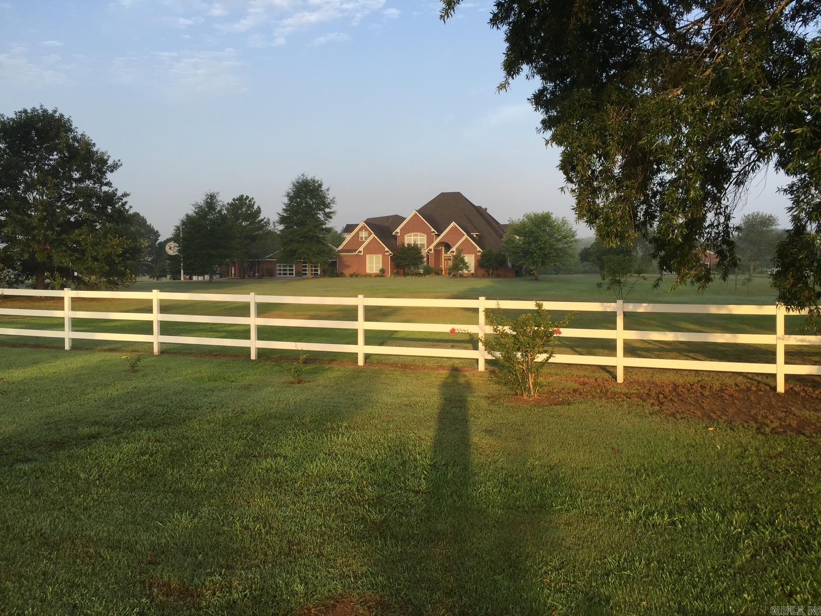 By appt only. Large house, two complete kitchens + kitchen in shop, upstairs refrig & W/D stays, 3 living rooms 2 w/built ins, a complete 12 person theatre w/Denon, Epson,& Klipsch, small library, a big game room w/ 2 game closets, a third floor craft/sewing room, balcony overlooks back yard pond w/pavilion & year around flowing creek, 2 walkout storages, each bedroom has it's own bath +two 1/2 baths. House has 4 car garage +4 wheeler parking area. Portico attaches house & working shop w/8200 Sq. Ft, has kitchen and full bath, showroom, shop, MH garage, warehouse & parts room. Greenhouse is 25' X 34', has running water and heat. Accessory bldg is 25' X 34' w/separate storage area for tractors, etc.,can convert to guest house. 6 acres in city limits, not in a subdivision. 7 HVAC units + 2 gas heaters, 11 garage doors. Lots of trees, white vinyl fence on front. New roofs 2024. Lots of other features not listed here. Call for list of items that do not remain.