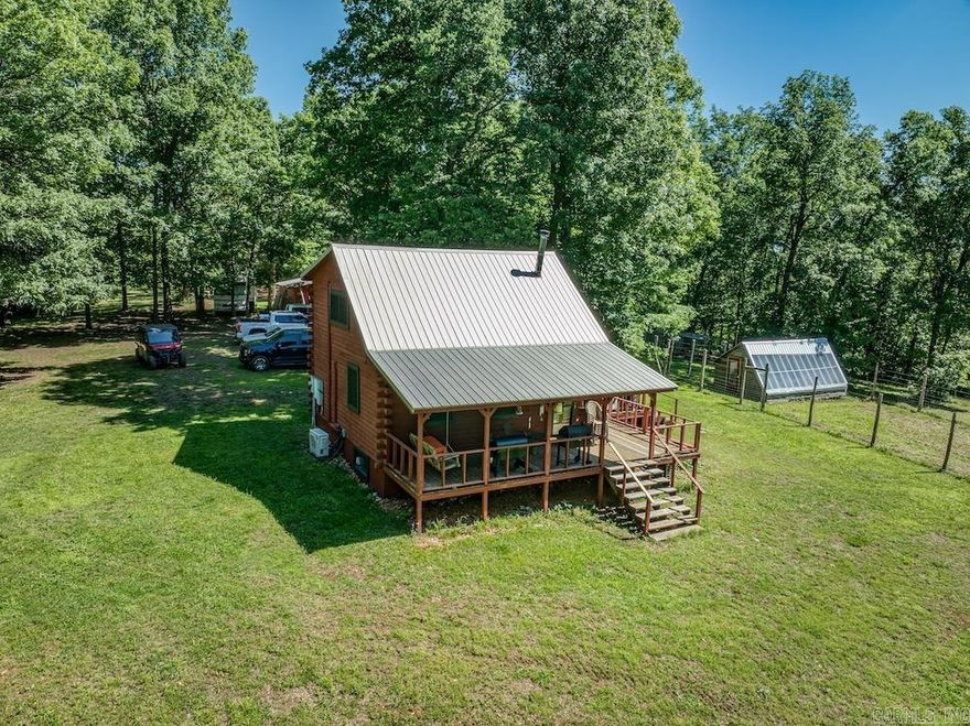 Tucked behind a gate at the end of McKnight Road near Guion, Arkansas, this private 283+/- acre Izard County property offers a secluded mix of timber, trails, water features, and recreational opportunity. The log cabin includes approximately 2 bedrooms and 1.5 baths with three functional levels, including a loft and basement with shower and washer/dryer hookups. Four mini-splits, a wood stove, and a propane heater provide year-round comfort. The mostly wooded acreage features mature hardwoods, rolling terrain, and Wilson Creek winding through the property, creating excellent habitat for deer, turkey, bear, and hogs. Miles of established ATV trails provide access throughout the land for hunting, recreation, and management. Additional improvements include 2 camper hookups, a greenhouse, barn, wood shed, and Conex storage building. Located near the White River and close to Guion, Mountain View, Mount Pleasant, and Batesville, this property is well-suited for a homestead, hunting retreat, or private recreational getaway.