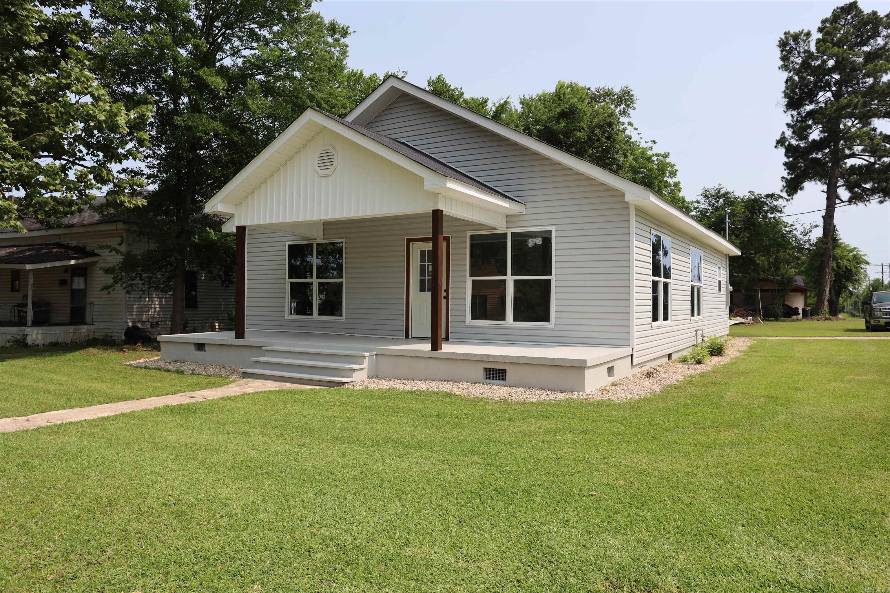 Newly Remodeled 1,344 Sq Ft Home on Corner Lot - Walk to Town! This charming 1,344 sq ft home sits on a corner lot within the city limits, offering a convenient location just a short walk to town. Recently remodeled, the home features a new roof, new siding, and new windows, providing both style and energy efficiency. Inside, you'll find fresh updates throughout, blending modern finishes with cozy living spaces. While the home does not include central heating or cooling, it's the perfect opportunity for buyers looking to add their own system or invest in efficient alternatives. A great option for first-time buyers, investors, or anyone seeking an affordable move-in-ready home in a walkable neighborhood.