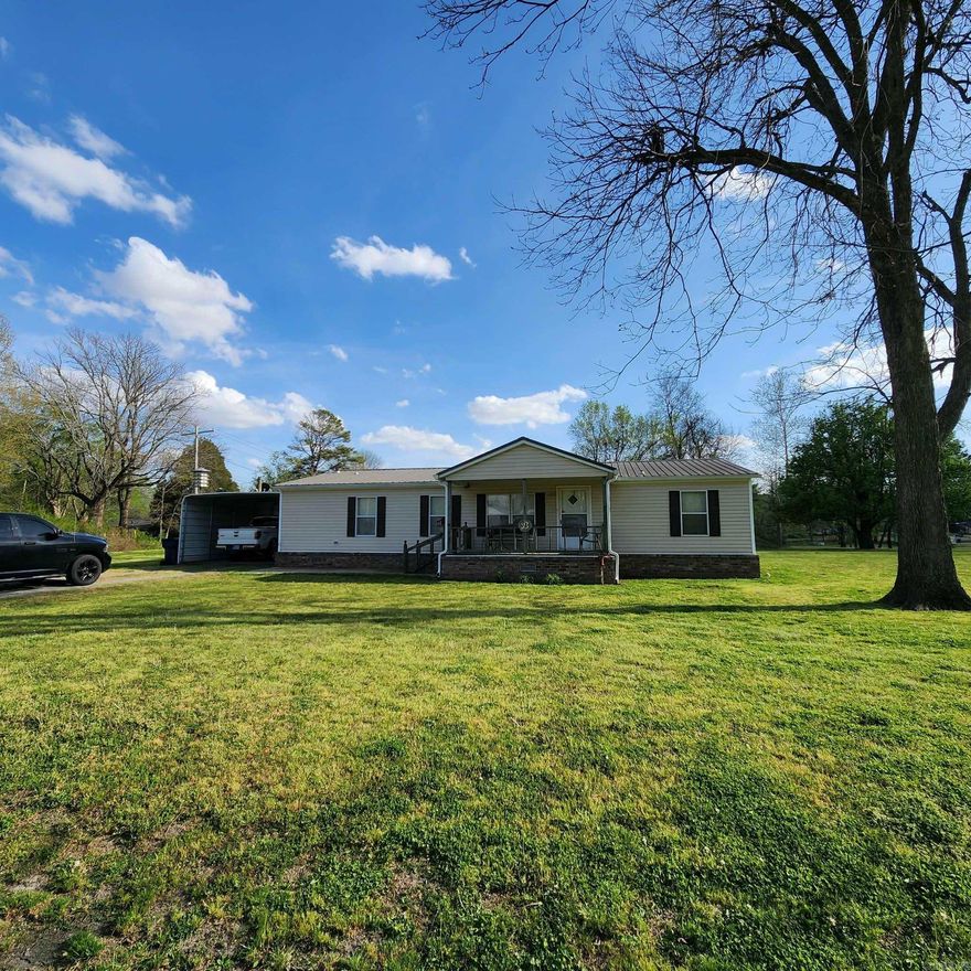 Beautifully manicured large corner lot, carport, shop, storm shelter, dog pen, shed, where a nice & tidy 3/2 home with covered front & back porch sits in the middle of this welcoming property.