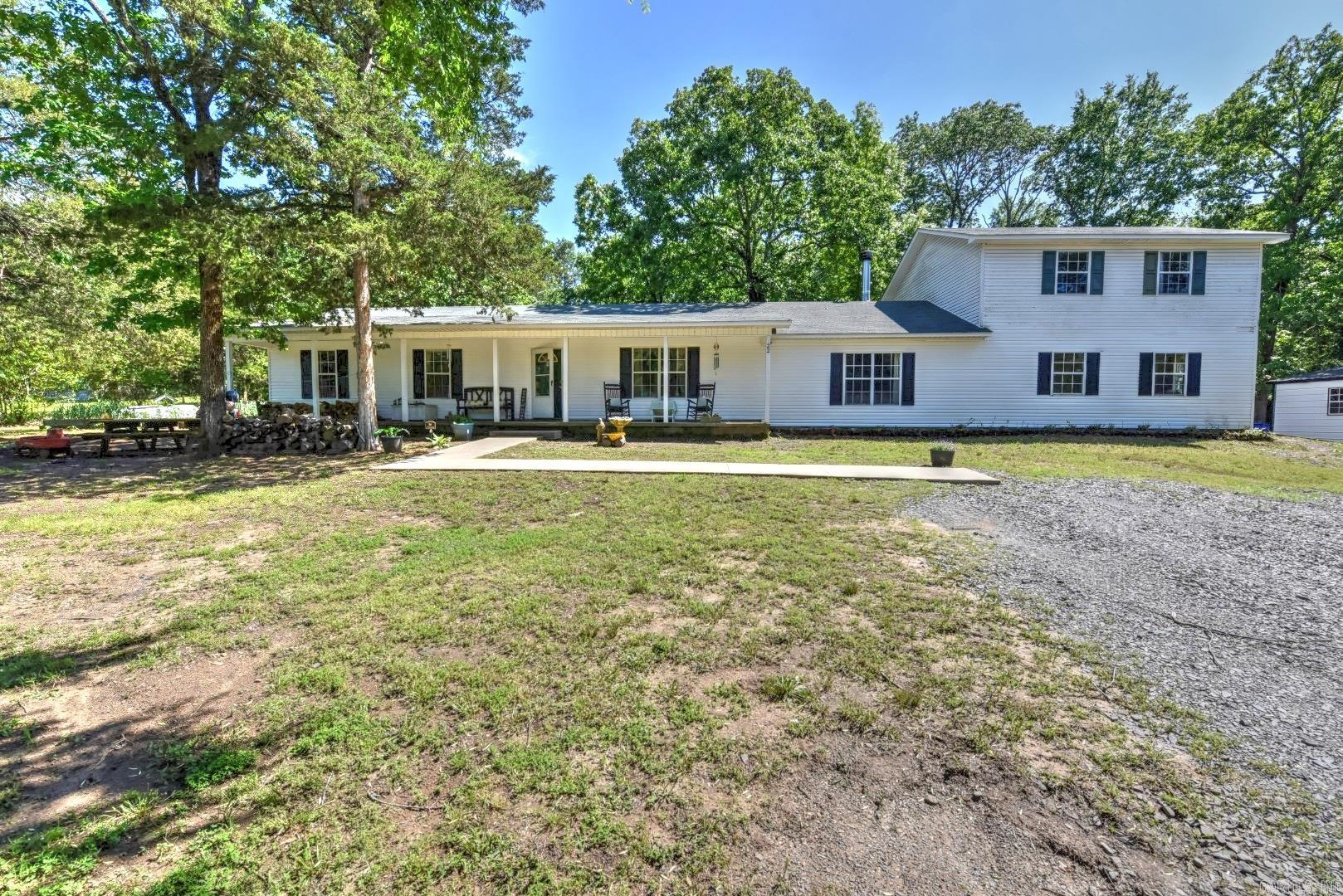 Charming Mini Farm Oasis between Greenbrier & Conway! Set on a picturesque parcel, this property is brimming with features that cater to both comfort & country living. The primary home sits on a spacious, level lot adorned with mature trees & offers wonderful outdoor amenities. Enjoy your morning coffee in the serene greenhouse or pick fresh herbs just steps from your kitchen in the dedicated herb garden. Let your chickens roam happily in the well-maintained coop, & fenced area, while family & friends gather in the expansive, open-concept living room and kitchen—ideal for making memories together. The main level features three comfortable bedrooms & two full baths, providing family-friendly functionality and privacy. Unwind on the welcoming front porch, or host summer barbecues & cozy gatherings on the back patio that overlooks the peaceful backyard. You'll also love the versatile shop/workspace—perfect for DIY projects & hobbies—as well as a covered carport to accommodate your RV, boat, or additional vehicles. Nature enthusiasts will rejoice in the meandering creek.