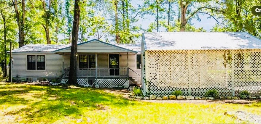 Back on the Market refreshed with new paint, new tile floors.Fisherman Dream lakefront Double Wide  Mobile Home sitting on 1.12 acres On Lake Conway. Newly updated with  new bathroom added sunroom,boat dock,shop with electric. Very private Property. Move in ready.Call today for a tour.
