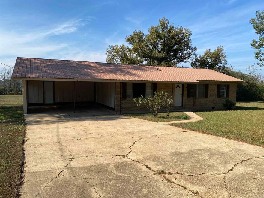 Country setting on 2 acres. This 3 bedroom 2 bath is being sold "as is where is".  Bedrooms are all original hardwood floors. The laundry room and bathroom that are attached will need the floors finished and some trim work. Home has a new hot water heater that has been installed. See attached survey for the 2 acre area.   Additional land can be purchased to the left of property 8 acres with shop and barn  mobile home with an acres and addtional 10 acres of timber less .03 miles up the road. All are listed.   Lender to determine financing.