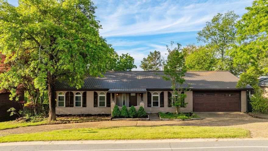 Beautiful home in Little Rock’s desirable Rivercrest neighborhood and zoned for Don Roberts Elementary! This all-brick home offers space and style with a layout that lives primarily on one level plus additional quarters below. The main level features a vaulted living room with fireplace, dedicated office/or formal living room, spacious dining area, sunroom, and a stunning modern kitchen with custom cabinetry, new appliances, and designer finishes. Fresh paint, new flooring, and updated fixtures create a crisp, contemporary feel. The reimagined primary suite offers a luxurious bath and oversized walk-in closet. Downstairs includes a second living area with fireplace, bedroom, and full bath—ideal for guests or in-law quarters. A circular drive, a metal roof, two car garage and prime location complete this exceptional home, perfect for entertaining and everyday comfort.
