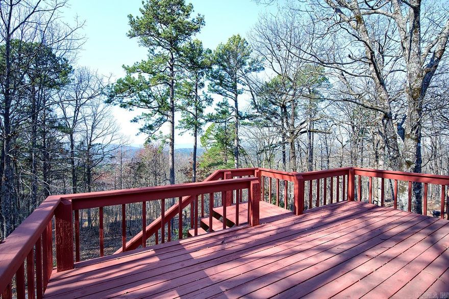 Peaceful Mountain View!!  This 2060 square foot 2-level home, with a breathtaking mountain vista, is perfect for multi- generational living, entertaining guests, or simply having ample space for hobbies, fitness/entertaining area, AND extra rooms for overnight guests. Custom built and very well maintained with new Anderson windows in 2021, new vinyl siding and leaf filter screens in 2018, new garbage disposal in 2022, new roof and HVAC system installed in approximately 2016. Featuring a large kitchen with pantry and abundant cabinetry, a welcoming great room, cozy woodburning fireplace, half bath, and primary suite on the main level. Two guest rooms, a full bath, and a bonus room with wet bar create endless opportunities for your creativity on the lower level. A separate heated and cooled workshop/storage room is an added bonus to your mountain retreat! Enjoy the relaxing, beautiful vista view from the expansive deck or the patio level.(Please be sure to view the virtual tour for the 360 degree tour of this beautiful home.)