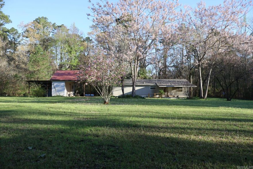 Country property with room to spread out—this manufactured home sits on approximately 3.5 acres and is being offered along with an additional 17 acres located just across the road.  The home offers around 1,400 square feet of living space, including an addition. The original manufactured home features 1 bedroom and 1 bath, while the added section includes 2 bedrooms and 1 bath. The addition has not been fully finished, giving the next owner the opportunity to complete it with their choice of materials and finishes.  The roof was replaced in 2021. Outside, the property includes a two-car carport with an attached storage room and an additional lean-to for extra covered space.  The 17 acres across the road already has water and electric on site and includes a natural spring-fed pond and a storm shelter. The acreage provides space to enjoy the outdoors and watch the local wildlife in a quiet country setting.