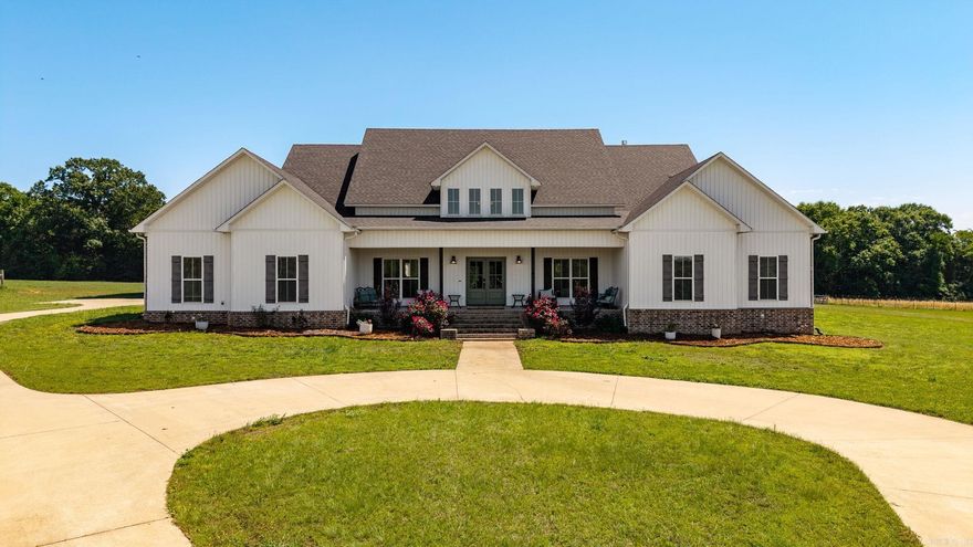 Welcome to this custom home featuring 5 bedrooms, 4.5 baths, 3,536 sq ft built in 2020 on 14.32 contiguous acres in Brookeview Estates. Brick and vinyl exterior. Grand 2-story entry with soaring windows. Custom cabinetry, granite countertops, dual dishwashers, dual ovens, walk-in pantry with dedicated refrigerator, gas fireplace, dedicated office with built-in shelving. Primary suite flows directly to bath, walk-in closet, and laundry. 5th bedroom above 3-car garage with en-suite bath. On-site propane system powers range, gas fireplace, tankless water heater, and whole-home Generac generator. Ground-mounted solar system (financing may convey — ask agent). Buried electric dog fence. Two additional lots (~7 ac) include workshop and storm shelter. Gas pad on property — mineral rights do not convey. Greenbrier School District. 10 min to I-40.