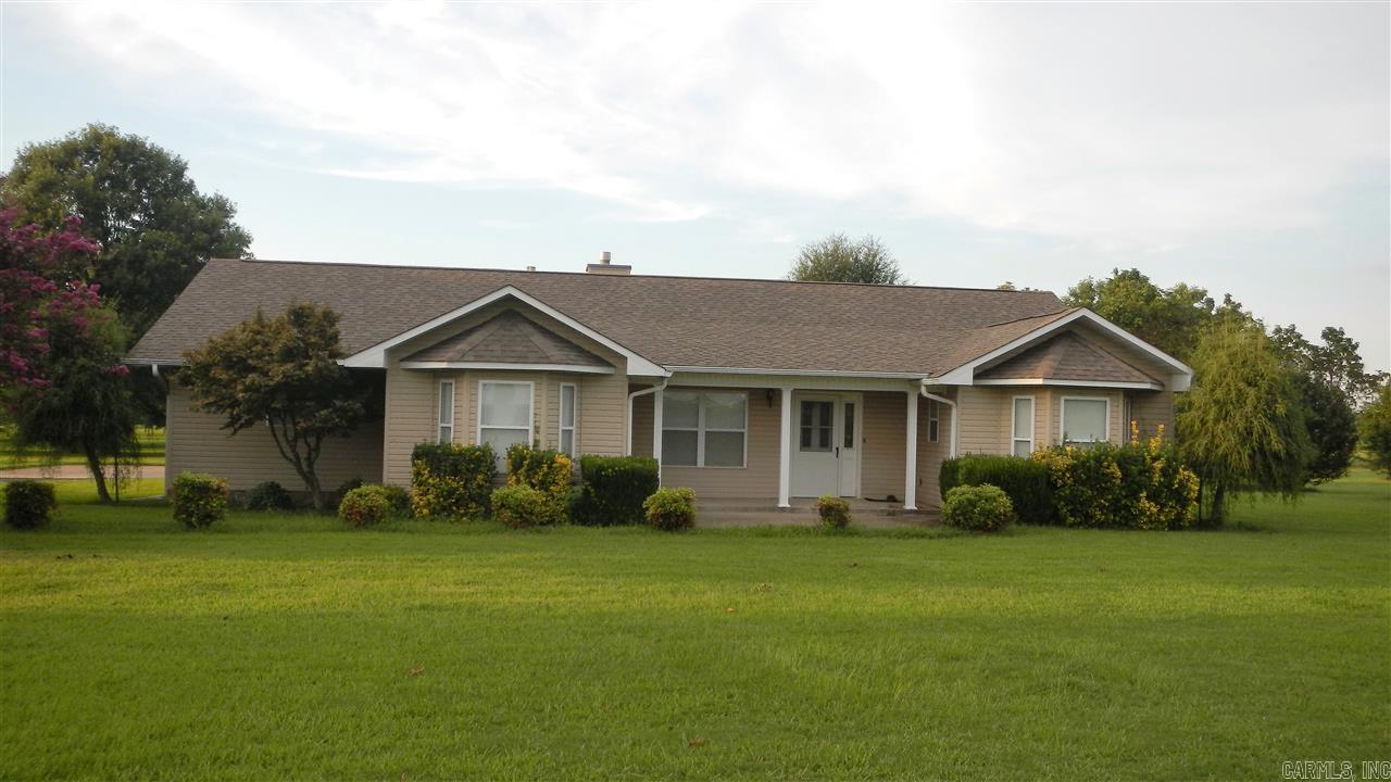Custom Blt home sitting on 2.5 lovely, level acres w/some fruit & pecan trees. Hm features laminate & tile floors w/carpet in the bedrooms. Greatrm w/FP & tray ceiling, sunrm, eat-in kit w/lots of cab. space, dining rm, laundry & mudrm. Split BR plan offers lg. master w/tray ceiling, bay window sitting area, Master Ba has lg Jacuzzi tub, his/her vanities + sep. shower. 2-Car side loading garage w/3rd utility garage, generator & 12x20 storage bldg. AGENTS - see Remarks pls.