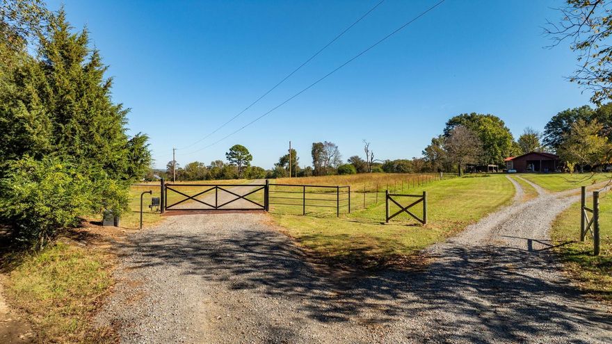 Welcome to this exceptional 54± acre property in the Greenbrier School District/Wooster Elementary School zone, featuring a stunning red iron shop house. The home offers 1,408 sq. ft. of heated and cooled living space with 9-foot ceilings, stained and sealed concrete floors, and tinted windows providing privacy and improved energy efficiency. Inside, you’ll enjoy central heat and air, an electric fireplace plus an emergency gas fireplace, a tankless water heater and much more. The kitchen comes fully equipped with all appliances conveying, including a gas oven, microwave, refrigerator and dishwasher. The 122' x 50' insulated red iron building includes a 30' x 50' lean-to, four electric insulated garage doors (three 12' x 12' and one 12' x 14'), and motorhome plug-ins on both sides. The shop also features a propane heater, an 18' x 50' storage loft above the living quarters, an office and a 6' x 10' safe room. The front yard is beautifully planted with bermuda grass. This beautiful acreage includes three ponds, two of which are spring-fed, offering natural beauty and versatility for recreation, livestock and peaceful country living.