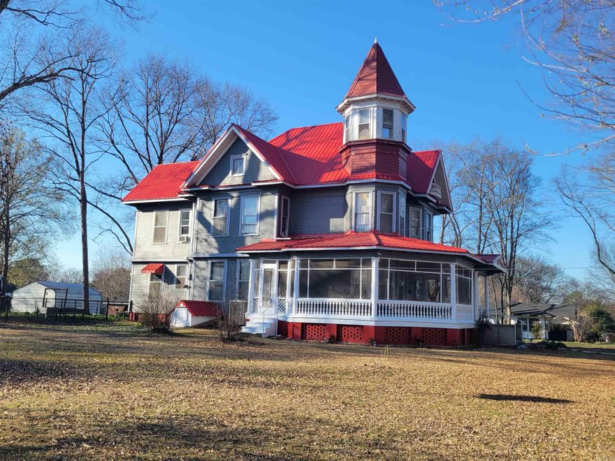 This is a truly beautiful home with solid bones and great character sitting on 3 lots. And though it is entered into the historic registry, modern improvements are allowed. House has 2 extra outbuildings as well as a 2 car garage. Some updates have been done recently to include, exterior paint, replacement windows and insulation blown into the attic. You have to view this home to appreciate all of it's beauty and quality craftsmanship. Enjoy sitting on the screened front porch or perched in the tower overlooking the yard. Grow a garden, restore the smoke house or finish the additional out building to use as an extra guest room, office or workshop. So many possibilities in a rare property you would be proud to call home.  See Agent Remarks