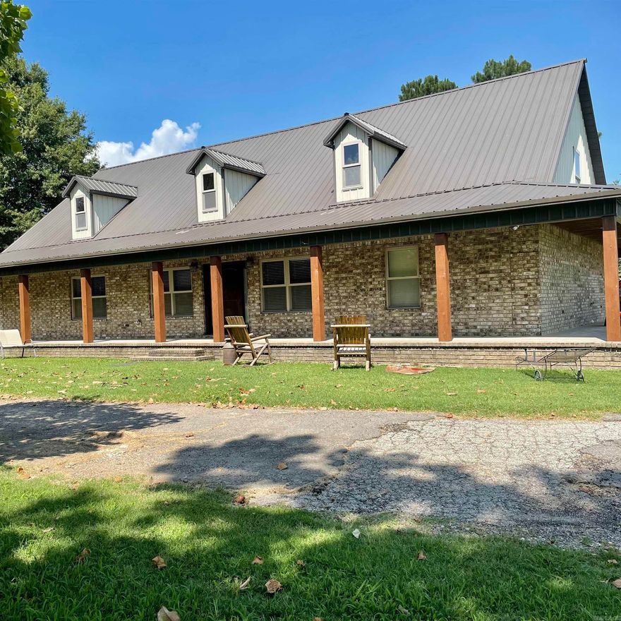 Escape to the peace and privacy of rural living with this stunning 3,195 sq ft two-story home in Wynne, Arkansas. Set against open farmland and surrounded by mature trees, this one-of-a-kind three bedroom, two bathroom property blends rustic charm with spacious, functional design. The exterior welcomes you with a classic country aesthetic, complete with a rap around covered porch perfect for rocking chairs and quiet mornings. Inside, the home opens to soaring ceilings, warm wood finishes throughout, and an open-concept layout that feels both grand and inviting. The main living space features a dramatic vaulted ceiling, abundant natural light, and seamless flow into the dining area and kitchen—ideal for everyday living or entertaining. The kitchen offers ample cabinetry and counter space while maintaining the home’s cohesive rustic character. A standout feature is the second-story loft and balcony walkway overlooking the main living area, adding architectural interest and flexible space for a home office, recreation area, or guest accommodations. The home’s thoughtful layout provides plenty of room for relaxation, work, and gathering, all while maintaining a cozy cabin-style.