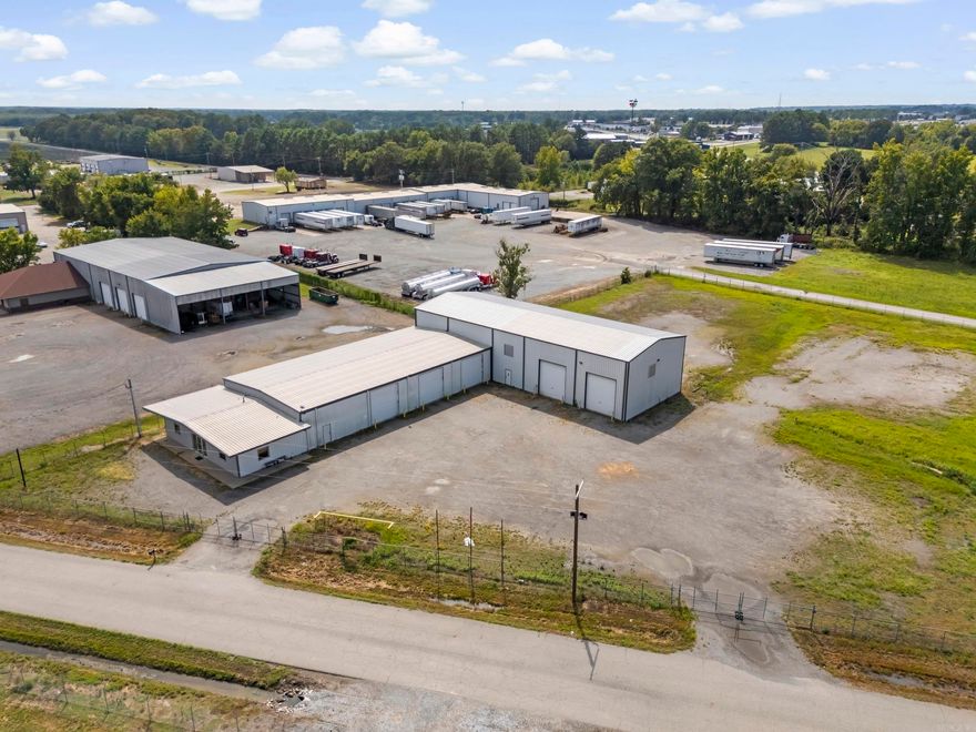 Fabulous new listing with unlimited possibilities for the space. 11,650 sq feet of work area plus lockable housed air compressor unit room.  1,000 sq ft of high end central heat and air office space with stained concrete flooring, private bathroom with shower area in office space. Fully furnished break room, full safe room with 6 " thick door.  3 phase electrical service.  10 ton power trolley bridge crane, wash bays with oil and water separator.  Heavily graveled lot with 4 entrance/exits for 18 wheeler traffic.  Three 14' tall power lift doors, four 16' tall drive through bays with power lift doors.  Shop area has multiple synchronized control power louvers and 5' cross ventilation fans.  Infrared heaters throughout.  Multiple 220 outlets , one three phase outlet, multiple air drops, and 110 outlets throughout.  Easy on and off Hwy.  67-167 exit and sitting on city limit boundary, just outside of city limits.