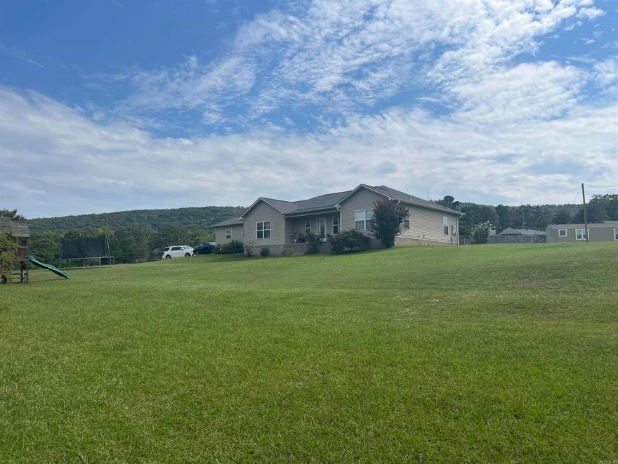 Location, location, location! With these stunning mountain views from your back yard, this charming 3 bed 2 bath home could be just the one for you. Fenced in back yard, enjoy country living all while just a short drive from the shopping, dining, and other attractions the city has to offer! It is located approximately 15 minutes from CHI St. Vincent Hospital and Walmart on central. It is approximately 20 minutes from Oaklawn. Don't miss out on this perfect blend of rural charm and city convenience!
