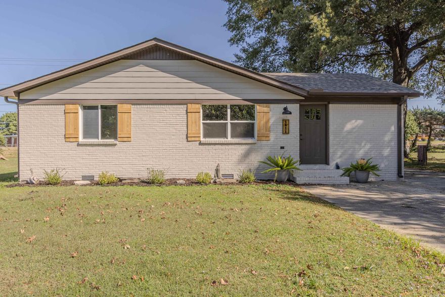 This completely remodeled 3-bedroom, 2-bath home is the perfect blend of modern updates and timeless charm! The open-concept layout connects the spacious living room and kitchen, featuring brand-new flooring, fresh paint, and recessed lighting throughout. The kitchen showcases granite countertops, stainless steel appliances, stylish pendant lights, a large island with bar seating, and plenty of cabinet space with dark wood finishes, brand new cabinetry, and open shelving.  The primary suite is a true retreat with double closets and a luxurious bathroom that includes dual vanities, granite countertops, a freestanding soaking tub, and a separate shower. Both bathrooms are fully updated, and the laundry room offers added convenience with cabinetry and counter space for extra storage. Outside, enjoy the curb appeal of freshly painted brick, wood shutters, and updated landscaping. The extended driveway and large covered carport provide ample parking, while the spacious backyard offers plenty of room to play, garden, or entertain. Everything has been doneāso all thatās left is to move in and enjoy!
