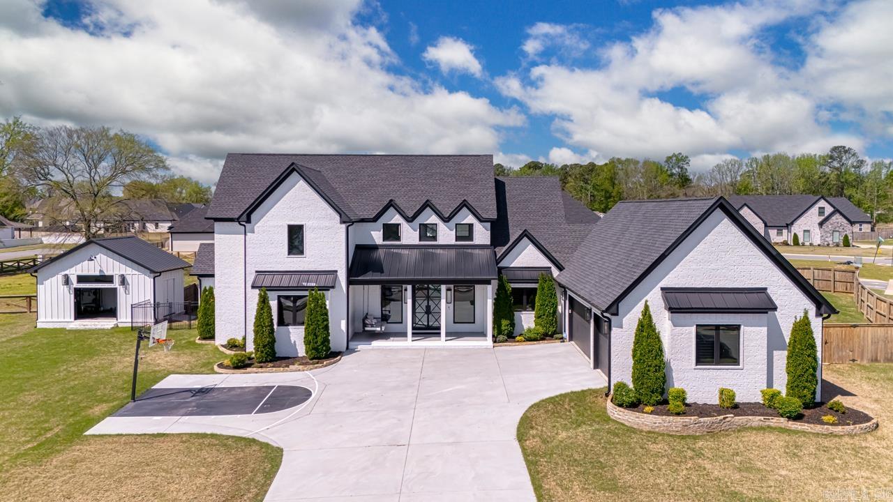 Welcome to this stunning, luxury home nestled within beautiful Hurricane Lake Estates but excluded from POA dues! From the moment you enter through the custom glass doors, the WOW begins! The living area is large and boasts a gorgeous floor to ceiling custom fireplace. The kitchen is a masterpiece with top of the line stainless appliances, an island larger than most kitchens and a pantry so large it makes organizing a breeze! Downstairs you find a lovely bedroom with full bath across the hall, a phenomenal master suite with a master bath fit for a queen and the closets.....AMAZING!There is a lovely dining space off the kitchen and an enclosed sunroom perfect for morning coffee! Upstairs features 2 oversized bedrooms and a full bath! All of this AND a view of Hurricane Lake! There is also a detached she shed with overhead door and double doors, ramp and its heated and cooled!In the oversized garage you will find an auto lift for easy storing in the attic and an electric car charger already wired! Current charger will not convey but wiring will be in place.DON'T WAIT! This home is amazing! Seller offering $5k in concessions. Some Furniture to convey!