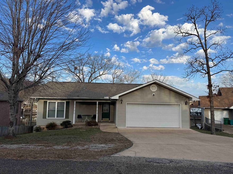 Lake Thunderbird 3 bed/3 bath home with over 3,000 sf of living space.  Features Include: A semi-open floor plan opening onto a sunroom with a fireplace, living room & sunroom both with a panoramic view of  the lake—great for watching 4th of July fireworks. The main floor has 2 bedrooms, 1 with its own bathroom, & a second bathroom. The adjoining 2 car garage has extra room for storage &  is prepped for a generator. The lower level has a large family room big enough for pool table.  Along with the mechanical room are 2 additional rooms: One that can serve as a guest room/office/storage & the other equipped with running water and a LOT of cabinets-formerly used for quilting OR it can be a third bedroom. This room & the family room both open onto a covered patio which has a 2nd wood burning fireplace.  Pride of ownership shows in maintenance & extra features such as separate water heaters for kitchen & bathrooms, a 12v light system in the family room, tubular skylights, easily accessible storage space under the stairs, wires installed & ready for a generator.  Dock. No SID fees. Stacked washer/dryer on lower level stays.  Bill of Assurance under Document tab.