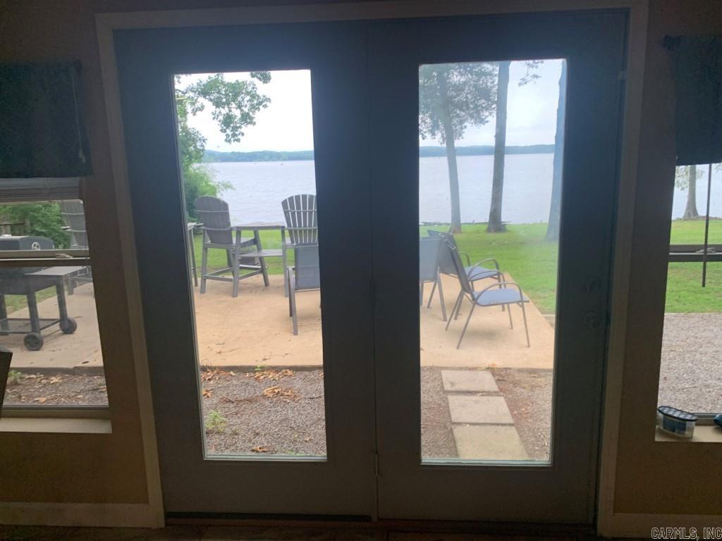 Lake front Property on Harris Brake Lake. No stairs to climb like most lake houses have. Mildly sloped back yard toward the lake. 255 Pine Valley Loop, Houston, Ar. Lakefront, on the south side of Harris Brake Lake. New metal roof installed 4-17-25. The 2 Br, 2 Bath, 1,972 sq ft home is ideal and in one of the best spots on the lake. Newer Appliances included. It has a 10 Camera Security system which can be viewed remotely, A wired Security alarm system. A newer HVAC Heat pump system with remote access along with a Pellet stove. A Marathon electric water heater. Boat pier and slide. All electric, well insulated home, 1st electric utility, Connect2 fiber internet, Perryville water, and on septic. Single level home with very little slope Makes it easier for those not liking to climb a lot of stairs. Up to a $1,000 allowance is given for any repairs, improvements, and/or toward buyer closing costs. No owner financing, No leasing, and No rent to own. Property is Agent Owned. Appliances stay with home. Home is still being used as a vacation getaway and is shown by appointments only.
