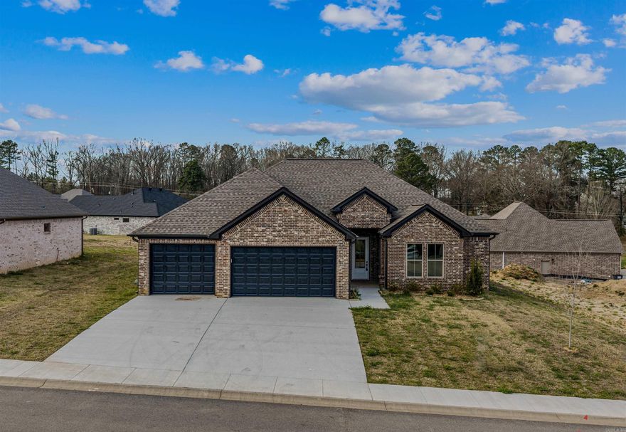 THREE CAR GARAGE!!! Large covered back porch, extra landscaping. LVP flooring , custom cabinets with large island, wall oven, gas cooktop. butler pantry, also regular pantry. Primary has tile shower with separate tub, large closet.