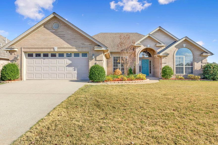 This delightful home features a well-designed split floorplan, all conveniently situated on a single level. With new paint, carpets, $16k roof, and countless  other updates, this home will make a wonderful place! The distressed hardwood floors add a touch of elegance, while the kitchen boasts Corian countertops and a decorative glass tile backsplash, complete with a charming breakfast bar. For the culinary enthusiast in the family, there’s a fantastic gas stove with a split oven. Imagine entertaining friends and loved ones on the covered patio, whether you’re watching the big game or catching up on your favorite series. The property sits on a spacious corner lot, backing up to a serene walking trail and fully enclosed by a fence. Inside, the gas log fireplace in the great room provides warmth and coziness. Plus, the oversized garage easily accommodates larger vehicles. Don’t miss out on this must-see gem!