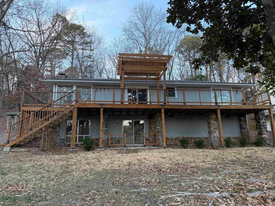 Lovely large home that has had extensive remodelling including new electrical, new appliances, one new air handler with AC and heat strip.  New waterproof vinyl plank flooring throughout and new covered deck and patio.  Open and expansive, the main floor is a delight for entertaining and includes two bedrooms and one and one half baths..  Downstairs boasts and incredible master suite with sleeping space, fireplace and den area, two walk in closets and amazing master bath.  Oversized garage and added parking are a plus.  One and a half lots for privacy make this a home you will want to check out.  Owner finance is a possibility.  Ask about terms.