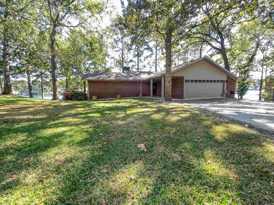 Stunning Waterfront Estate on Lake Hamilton Experience lakeside living at its finest in this gorgeous two-story brick home, perfectly positioned to capture panoramic views of Lake Hamilton. Nestled in one of the most sought-after neighborhoods lined with luxury homes, this property offers an ideal blend of elegance, comfort, and accessibility. The gently sloping, oversized lot leads to your own double-stall boat dock and convenient private boat ramp—perfect for lake lovers and outdoor enthusiasts. Thoughtfully designed concrete pathways surround the home, providing easy handicap accessibility and seamless movement around the grounds. A spacious circle driveway offers ample parking and an impressive entrance for guests. Inside, you'll find numerous modern updates that enhance both style and functionality, creating a move-in-ready retreat ideal as a primary residence, vacation home, or investment property. This exceptional Lake Hamilton home delivers unmatched views, premier amenities, and a prime address—an incredible opportunity to own a piece of waterfront luxury.