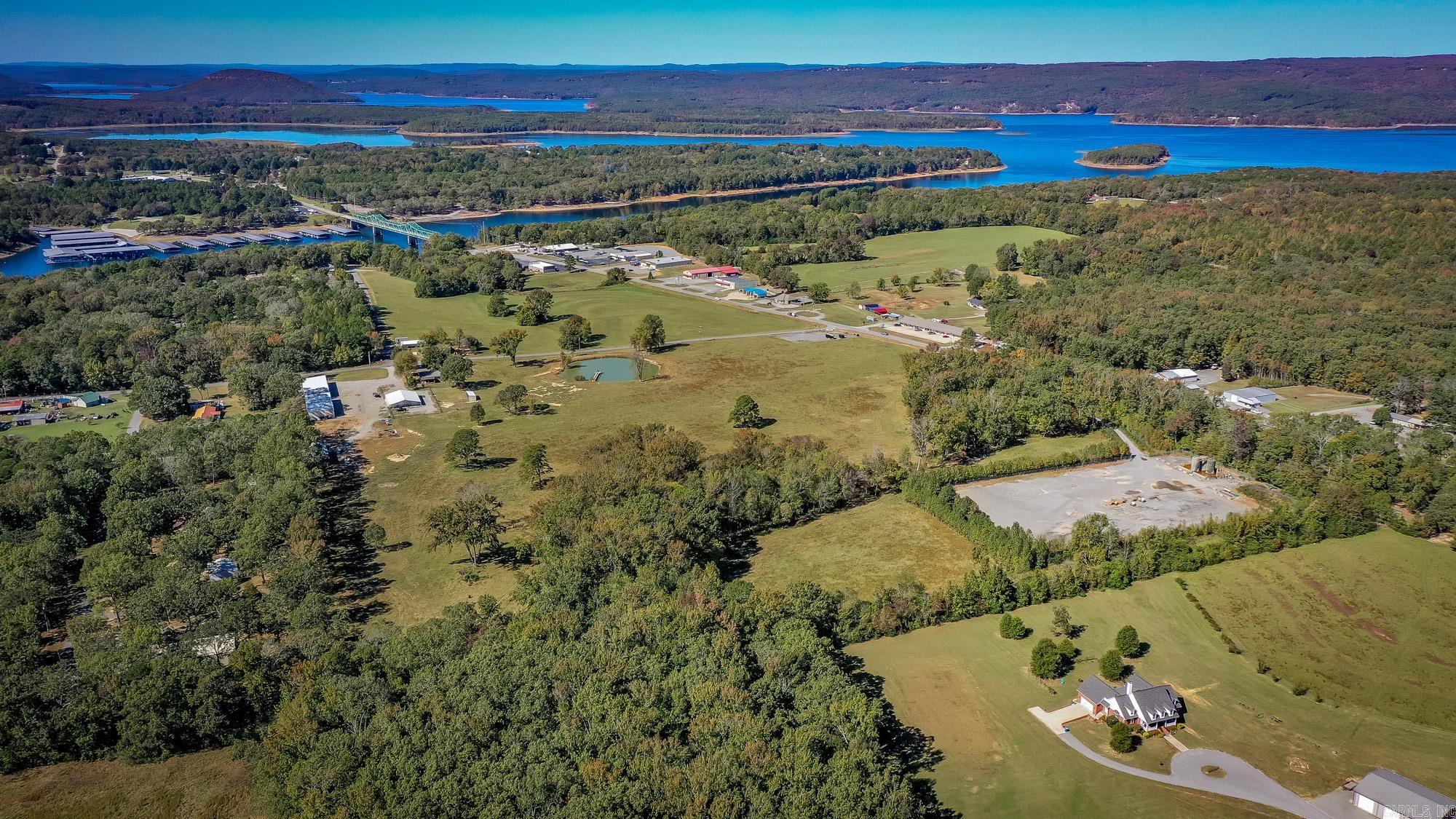 Discover the perfect blend of privacy, income potential, and natural beauty with this stunning 40+/- acre property located just minutes from the sparkling waters of Greers Ferry Lake. Whether you're looking for a serene retreat, a farm, or a turnkey investment, this property has it all. Gently rolling land with a mix of open pasture and wooded areas, ideal for recreation, livestock, or future development. A charming, completely remodeled, fully furnished home currently being used as a short-term rental offering guests a peaceful getaway near the lake. New 16-bay boat/rv storage with electric and concrete floors. Excellent rental history on both and ready to generate income from day one. 3-stall barn. 54x60 insulated shop perfect for storing equipment, vehicles, or running a business. Includes concrete floors, electric, 6 overhead drive-thru doors. 30x64 pole barn great for hay storage, livestock shelter, or additional workspace. Stocked pond with pier to enjoy fishing, relaxing, or watching the sunset. Prime location just minutes from Greers Ferry Lake. This property offers endless possibilities! Seller will consider selling separately. See docs.