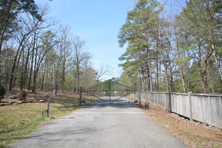 Full Top of Mountain View on Mills Mountain Estates. Vista view of Pinnacle Mountain and Chenal Mountain, as well as far NE as Jacksonville Air Base. Wooded and undeveloped. Public Water and a Fire Hydrant at the corner of the property. Good building sites on this 5 acres of Premium Land in a Gated Private Subdivision.