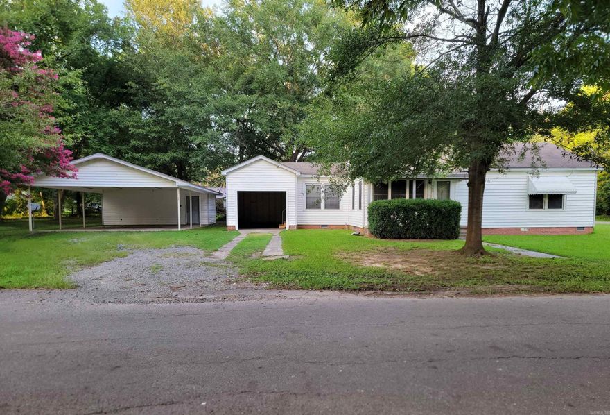 Move-In Ready! This very nicely restored 2-bedroom, 1-bath home offers 1,156 square feet of comfortable living space, perfectly situated on a little over two lots, located on a corner. Whether you're a first-time buyer, a couple, or a small family, this home is a fantastic opportunity.  Property Features Include: New electric surface range;  New stainless steel refrigerator;  Double-pane windows for energy efficiency;  Hall bathroom with a tub/shower combo, with large storage cabinet;  Detached double carport - 24x29 ft.;  Detached double carport storage room with A/C unit - 24x11 ft. (264 sq. ft.);  Large, shaded backyard with 4' chain-link fencing—perfect for kids, pets, or entertaining;  All-new flooring: durable vinyl plank and vinyl throughout, over original hardwood flooring;  New water heater;  Front porch with concrete flooring;  Patio is just outside the back door and behind the garage back wall;  Single open garage with door to the house and outside patio;   Additional storage room accessible from the patio;  Small metal storage building at the back of lot;   Don't miss the chance to make this inviting home your own—schedule a showing today!