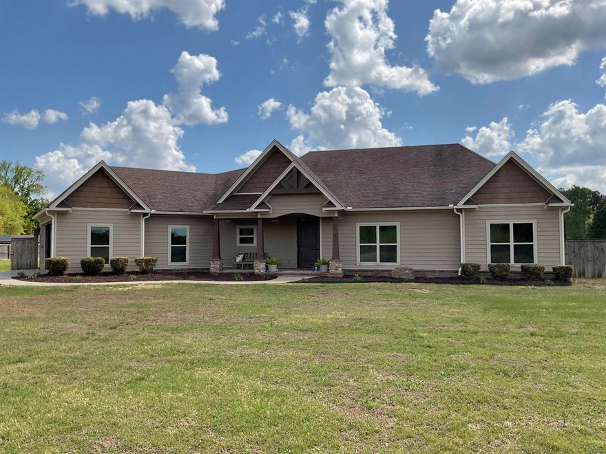 NEED YOUR SPACE AND A BEAUTIFUL BUILT HOME? What a jewel you will discover here.  Sitting on 3.24 acres this immaculate 1959 sq.ft. home should be your choice.  What a wonderful kitchen with more than ample cabinets, pull out drawer pantry, lazy susan, small appliance hideaway, hard surface countertops, breakfast bar, tile backsplash all open to the dining & family room. Other wonderful amenities include gas log fireplace, concrete stained flooring, beautiful built-ins, crown molding thru-out, jack/jill bath between 2 guest rms.  Master suite is tray ceiling & features a remarkable bath equipped with hard surfaced topped vanities, deep soaking tub, walk-in tiled shower with a river stone floor & sitting bench & a huge walk-in closet with built in shelving & 2 built in dressers. Double auto door garage & pull down attic storage leads into the mudroom. Brand new Ruud heat/air system, 50 gal Rheem water heater.