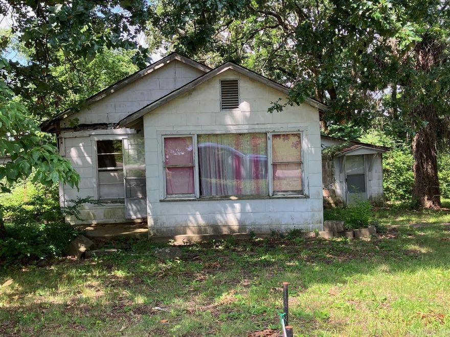 Charming cottage with 3 bedrooms and 1 bathroom. Original wood floors, needs roof, large rooms, stairs down to both extra bedrooms. Primary bedroom on main level. Basement with shower.