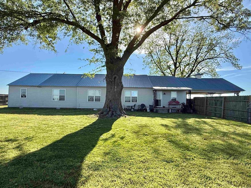 Escape to the countryside with this charming 5 bed, 3.5 bath home perfectly situated on a generous 0.75 +/- acres. This property offers the perfect blend of privacy and room to roam. The inviting layout features ample space for family gatherings and entertaining. Enjoy quiet mornings on the porch or evening sunsets on the spacious back patio with tons of usable land. Perfect for those looking for a peaceful retreat with space for a large garden or outdoor entertaining.  Don't forget about the in law quarters! Lots of new updates!! Guest house build 2015 with living space & bathroom. New metal roof and windows in 2015, 2020 dishwasher replaced, 2021 high efficient on demand water heater, 2022 septic system replaced second bathroom renovated, plumbing throughout replaced, kitchen flooring, double oven replaced, mud room storm door replaced, 2023 brick mailbox built, glass cook-top replaced, 2024 front and master bedroom storm doors replaced, guest house and main house HVAC systems replaced, 2025 first bathroom renovated, gas plumbing replaced throughout, HVAC duct in attic replaced. Also has a 20 X 25 SHOP!! Also has a barn with a loft. Don't miss this amazing property!!!