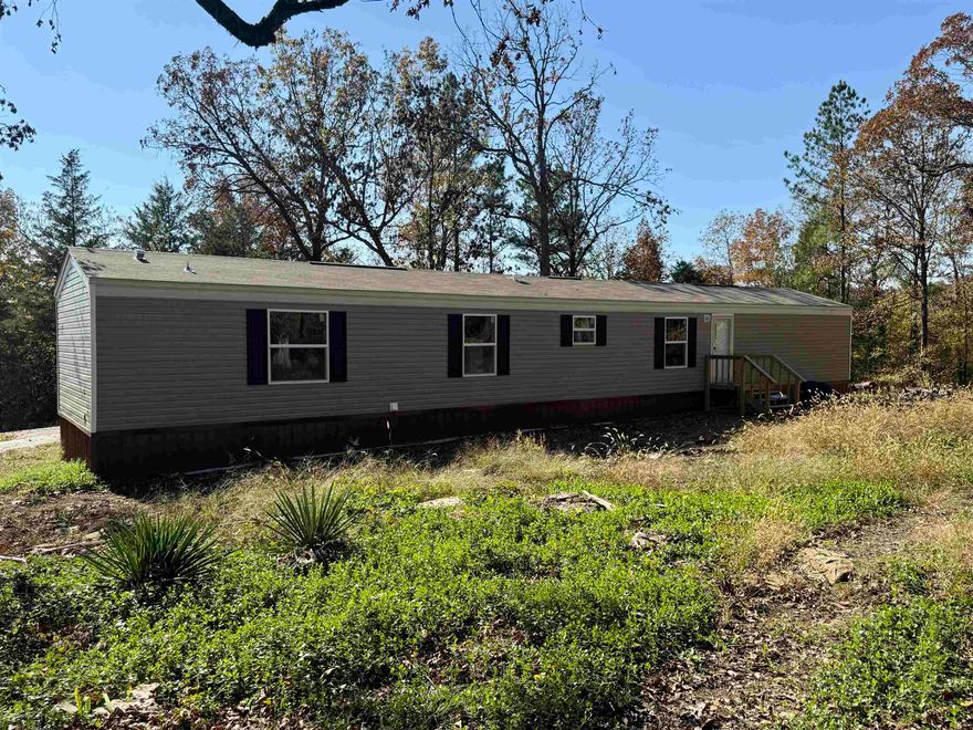 92+-Mostly wooded acreage in the beautiful Ozarks! Prime hunting ground! Trails cleared to several food plots. Deer stands in place. Brand New Clayton mobile home set up and ready for you to move in! Metal skirting with plastic laid underneath and water pipes are wrapped with heat tape & ready for winter. 3 bedrooms 2 full bathrooms plus a bonus room (office space). Primary bathroom has a large walk-in shower and a garden tub. Kitchen has a cabinet island, a Frigidaire dishwasher, elec stove, venthood, & refrigerator. 40 gal water heater & central HVAC (all new). Laminate flooring throughout. 2 small storage buildings & 1 large storage building and 1 20ft container convey. There is lots of room here to do numerous things. Unrestricted and quiet. Some fruit trees on the property but mostly timber. New blacktop circle driveway adds to the charm of this property. Has been used as a Honey Bee Farm with great success. It's a beautiful drive to the property along Martin Creek with rock bluffs on one side and the creek on the other.  NAEC Co-op electric company. Well water.  Wonderful location, not far from Spring River & Historic Hardy Town. Schedule your viewing today!