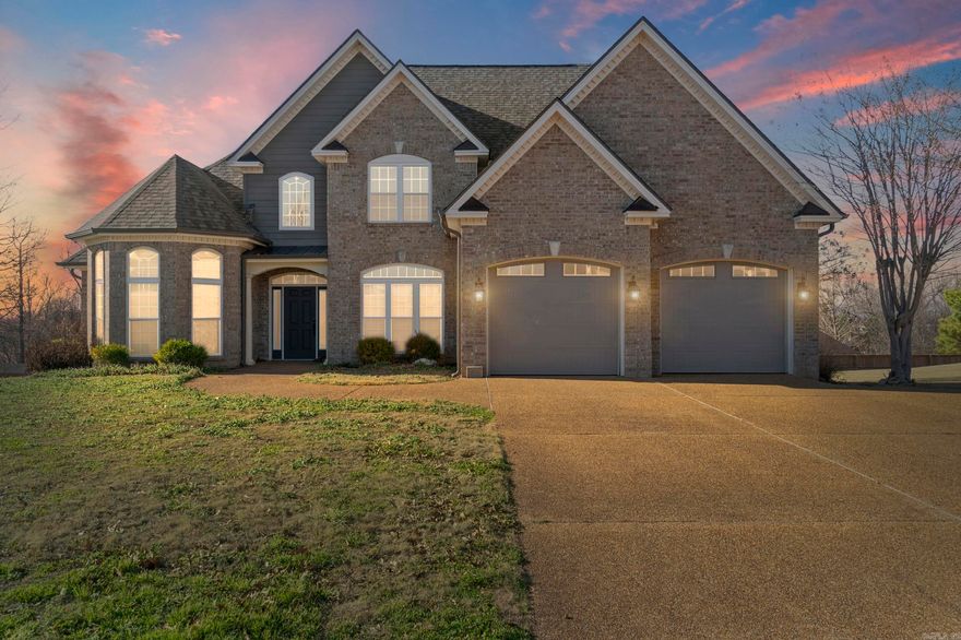 Beautiful curb appeal welcomes you into this exquisite custom-built home featuring an open floor plan with 4 bedrooms, 3 full baths, and a theatre room or 5th bedroom. The theatre includes professionally installed surround sound, projector, and screen. The first-floor primary suite offers a bay-window sitting area, two walk-in closets, soaking tub, walk-in shower, new his-and-her vanities, quartz counters, and tall ceilings. Also on the main level are a guest bedroom, full bath, and laundry. The garage opens directly into the kitchen for easy grocery access. The kitchen features ample updated cabinetry, a work island, granite countertops, new fixtures, and space for a breakfast table, plus a separate dining room. The open family room has tall ceilings and a fireplace. Upstairs includes two bedrooms, a full bath, and the theatre room. Enjoy sunsets from the large deck. Backyard offers privacy fencing, a very nice extra garage, and underground sprinklers. Recent updates include a new roof, gutters, garage doors, and fresh exterior paint and some new windows! Don't miss this gem on Crowley's Ridge.