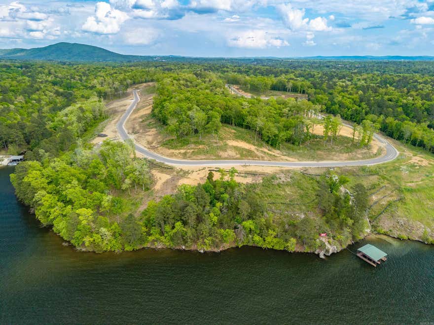Premier main-channel lakefront estate homesite offering approximately 200' of pristine shoreline along Lake Hamilton. This exceptional property commands breathtaking panoramic views and delivers a truly private, resort-caliber setting. Underground utilities preserve the natural landscape, ensuring a clean, unobstructed backdrop for a distinguished, custom residence of the highest eminence. Restricted to upscale 3500 square-foot homes! Available utilities include high-speed internet, city water and city sewer. Boundary lines are for illustrative purposes only.