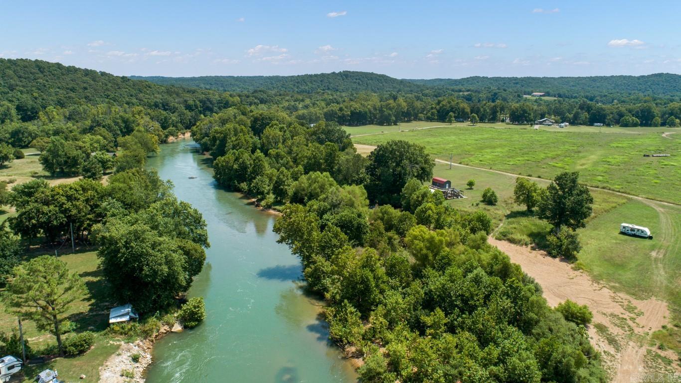 135 Acres on the Eleven Point River - Randolph County, AR Discover a rare opportunity to own approximately 135 acres more or less along the beautiful Eleven Point River in Randolph County, Arkansas. This versatile property offers a blend of open pasture, wooded hillsides, and scenic river frontage. A nice pond, two barns, and a workshop add to the land's functionality, making it well-suited for livestock, recreation, or development. A dedicated river lot is included with the land providing great wade in access to the river. The Eleven Point River is a clear-flowing Ozark stream known for exceptional sportfishing, including smallmouth bass, walleye, and more. Canoeing and boating are popular on this scenic cool water river. The property also provides excellent deer and turkey hunting opportunities, making it a true sportsman's retreat. Several prime homesites are located throughout the land, offering the perfect setting to build your dream home or retreat with stunning views of the Ozarks. Additional features include access to a community boat ramp, enhancing your ability to enjoy boating, fishing, and river recreation. Whether you're looking for a working farm, hunting property, or