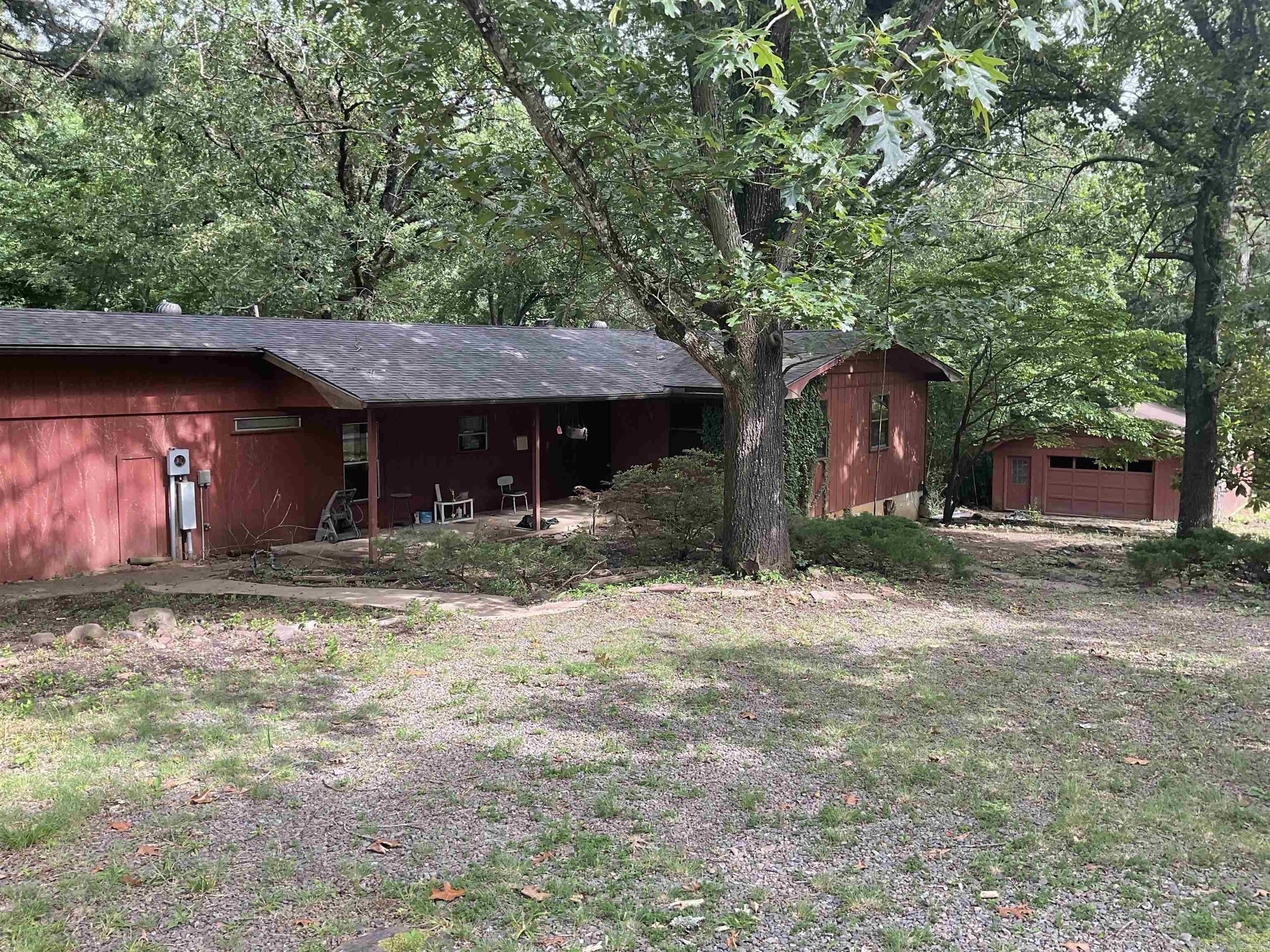 Great Location with lake access and a tad over 3/4 of an acre but needing TLC and some repairs this 3BR/2BA has the capability of being right up your alley if you are a handy man. Two den areas with one having woodburning fireplace but able to see fireplace in second den area. There is a lower basement room with outside door. There is also a 24x28 detached garage. sold "AS IS".
