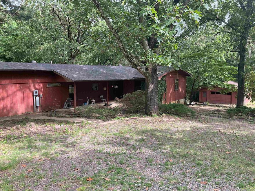 Great Location with lake access and a tad over 3/4 of an acre but needing TLC and some repairs this 3BR/2BA has the capability of being right up your alley if you are a handy man.  Two den areas with one having woodburning fireplace but able to see fireplace in second den area.  There is a lower basement room with outside door.  There is also a 24x28 detached garage.  sold "AS IS".