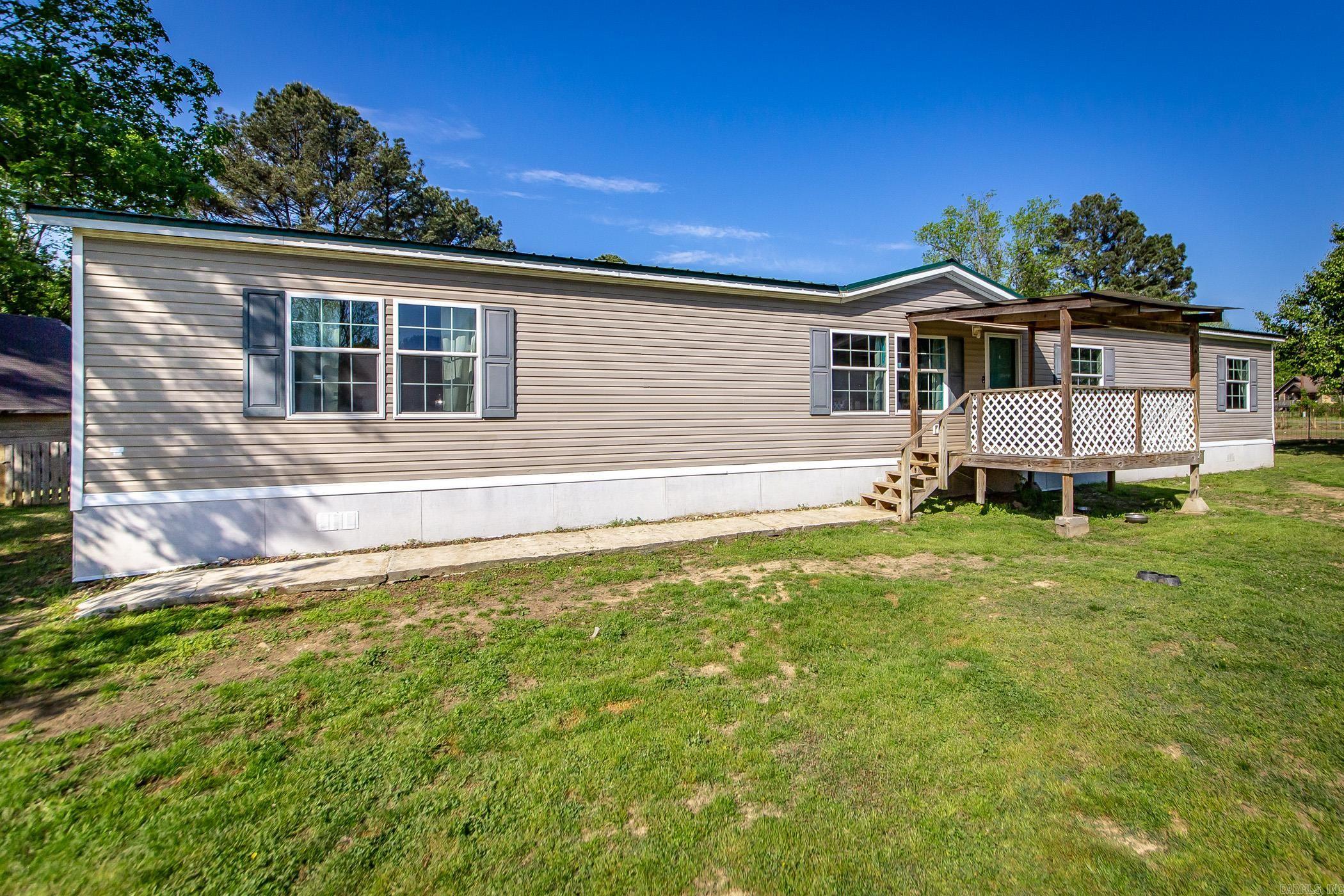 Charming country retreat just minutes from town! Welcome to your perfect blend of peaceful country living and city convenience. Nestled on 1.52 acres just outside of city limits, this well maintained mobile home offers privacy, space, and endless potential. This property is on permanent foundation and offers an open concept living area, 4 spacious bedrooms, 2 bathrooms, a functional kitchen ready for your personal touch, a walk in pantry that could also double as an office space, and much more -- New hot water heater 2025. Septic last serviced 2022. All new kitchen appliances 2022. New metal roof in 2021. Schedule your showing today! It won't last long!