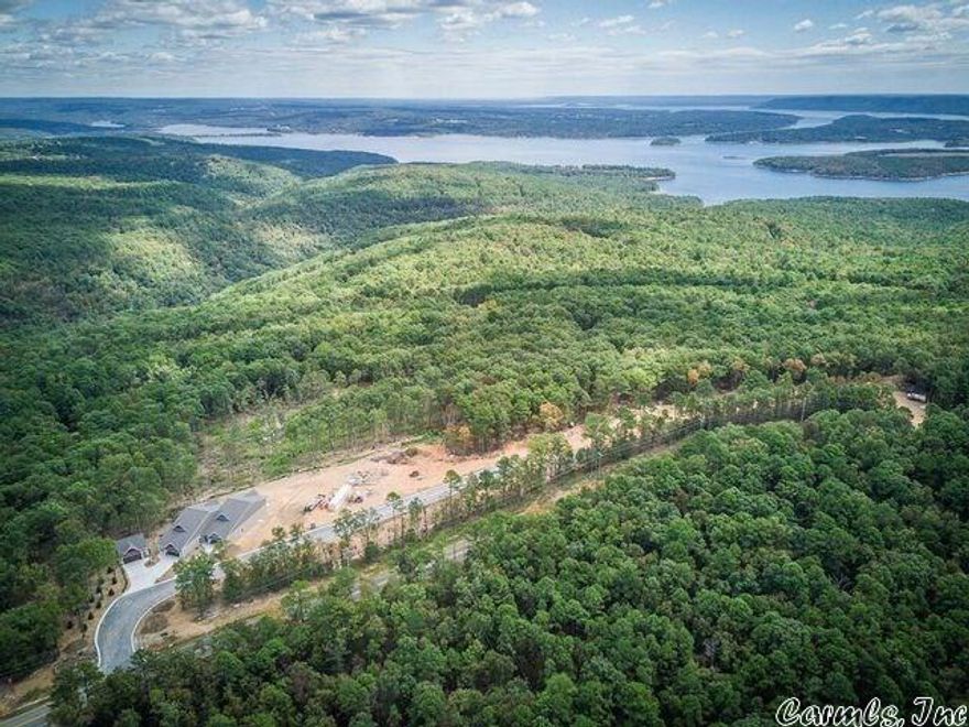 Panoramic views of Greers Ferry Lake from Osage Point development offering custom townhomes, vacant lots, & a library of floor plans from the builder (Ozark Resort Homes) or bring your own floorplan! Lake view lots include water extension, gravity sewer, underground electrical extension & phone. Ask for complete list of lots & prices; lots can be purchased in 'bundled' groups to provide larger building area.  This lot does NOT have an additional lot across the street for Toy Garage.  Ask about Exhibit A