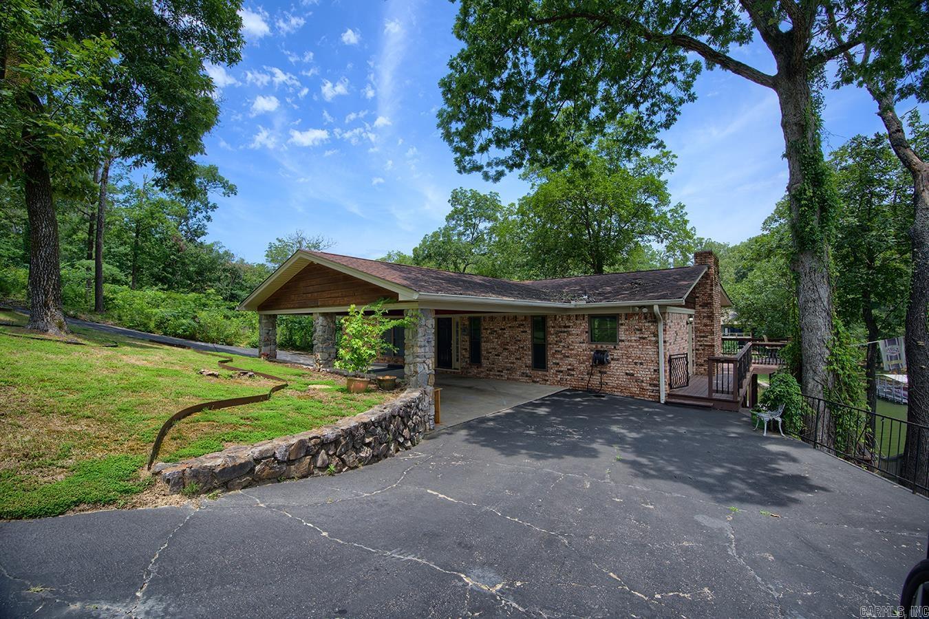 Lake Hamilton Waterfront Retreat – 4 Bed, 2 Bath | 2,700 Sq Ft Experience the ultimate in lakefront living with this spacious and inviting home located on the beautiful shores of Lake Hamilton. Boasting 4 bedrooms, 2 bathrooms, and 2,700 square feet of living space, this home is designed for comfort, functionality, and relaxation. The open-concept main floor includes a welcoming den, dining area, and a kitchen outfitted with granite countertops and a tile backsplash—perfect for cooking and entertaining. A highlight of the home is the large great room downstairs, featuring a gorgeous stone fireplace—a cozy centerpiece for family gatherings or quiet evenings by the fire. Additional features include a generously sized utility/laundry room and a private boathouse with a boat dock, making lake access a breeze. This home has everything you need for full-time living or the perfect lake getaway. Don’t miss your chance to own this lakeside gem on Lake Hamilton!