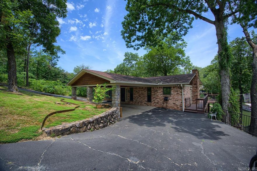 Lake Hamilton Waterfront Retreat – 4 Bed, 2 Bath | 2,700 Sq Ft Experience the ultimate in lakefront living with this spacious and inviting home located on the beautiful shores of Lake Hamilton. Boasting 4 bedrooms, 2 bathrooms, and 2,700 square feet of living space, this home is designed for comfort, functionality, and relaxation.  The open-concept main floor includes a welcoming den, dining area, and a kitchen outfitted with granite countertops and a tile backsplash—perfect for cooking and entertaining. A highlight of the home is the large great room downstairs, featuring a gorgeous stone fireplace—a cozy centerpiece for family gatherings or quiet evenings by the fire.  Additional features include a generously sized utility/laundry room and a private boathouse with a boat dock, making lake access a breeze.  This home has everything you need for full-time living or the perfect lake getaway. Don’t miss your chance to own this lakeside gem on Lake Hamilton!