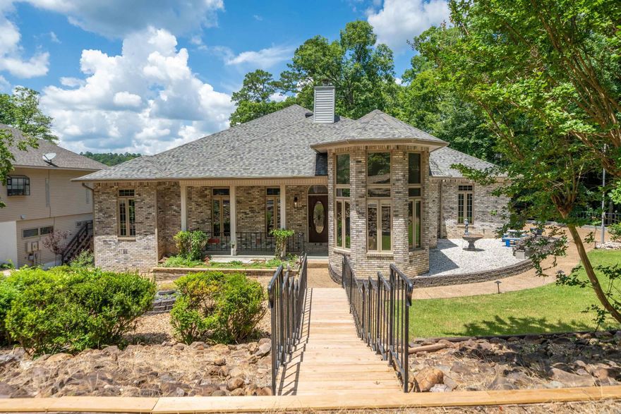 Lakefront luxury on Lake Cortez! This expansive 4 bedroom, 3 bathroom brick home spans two stories, offering breathtaking lake views and a private boat house complete with a lift. Inside, discover spacious living areas, natural lighting throughout, and a grand master suite overlooking the serene waters of Lake Cortez. Additional features include a wood burning fireplace, recessed lighting, full wet bar downstairs, and newly painted upper and lower decks, perfect for relaxing and unwinding or entertaining guests. This magnificent lakefront retreat is truly a rare find—a blend of classic architecture, modern amenities, and unparalleled natural beauty.