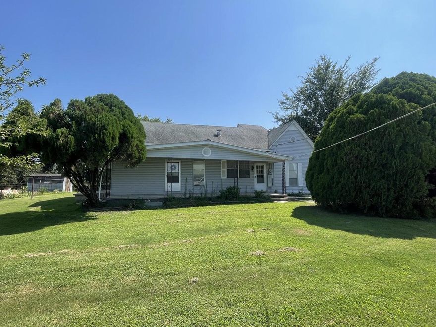 Own a piece of history with this 1800+ sq ft home on 2.11 acres +/- with shop in the small community of Violet Hill. Home was built by the community Doctor who had an office at the house and made house calls by horseback. Home features 3 bedrooms, 2 baths, large open kitchen dining room flows into the living room which features gas logs, bonus room, dedicated laundry and porches on all sides, several outbuildings including a detached double garage, metal building with lean to. Property has a fenced area with freeze proof tank and several outbuildings