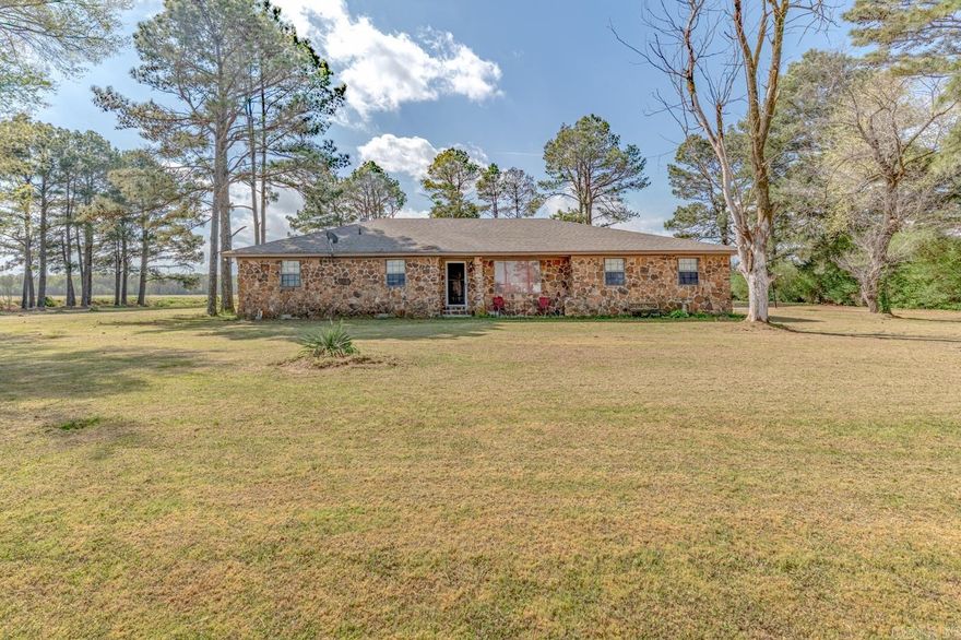 Welcome to Market 2115 Highway 64 in Wynne, Arkansas within the Wynne School District. Situated on a .91 +/- acre level lot sprinkled with shade trees, is a 1960 built Ranch style home. The exterior is wrapped in stone, topped with architectural shingles, and accented by a covered front porch, 2 car side entry attached carport, and 440 sf sunroom with wood burning fireplace. The interior features 2,408 sf of well laid out living space and contains a large living room w/ built in shelving and an open concept kitchen/dining area. The kitchen offers bar seating and ample cabinet & countertop space. The Master holds an en-suite with dual vanity and shower/tub combo. The guest wing features a generous bedroom with built-in desk and an en-suite with walk-in shower. 3 additional bedrooms and a large laundry/utility room complete the layout. You'll love the large open yard framed by mature trees and detached outbuilding with metal roof for storage or workspace. Conveniently located just 4 miles to favorite local amenities and less than an hour to Jonesboro, AR and Memphis, TN. Call today to schedule your tour and make this house your home.