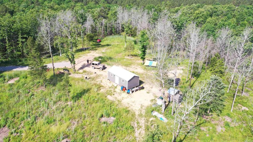 Rare opportunity to own 42.21 acres bordering the Ouachita National Forest — hard-to-find acreage offering privacy, recreation, and breathtaking natural beauty. This wooded property features a gradual hill with an established road leading to the top, where a scenic homesite awaits with a cabin, electric pole already in place, and beautiful long-range views. Two ponds enhance the landscape and attract wildlife, making this an ideal retreat, hunting property, or future homestead. The seller has thoughtfully cleaned and improved the land while preserving its natural setting and character. If you’ve been searching for acreage adjoining national forest land, this is a rare find.