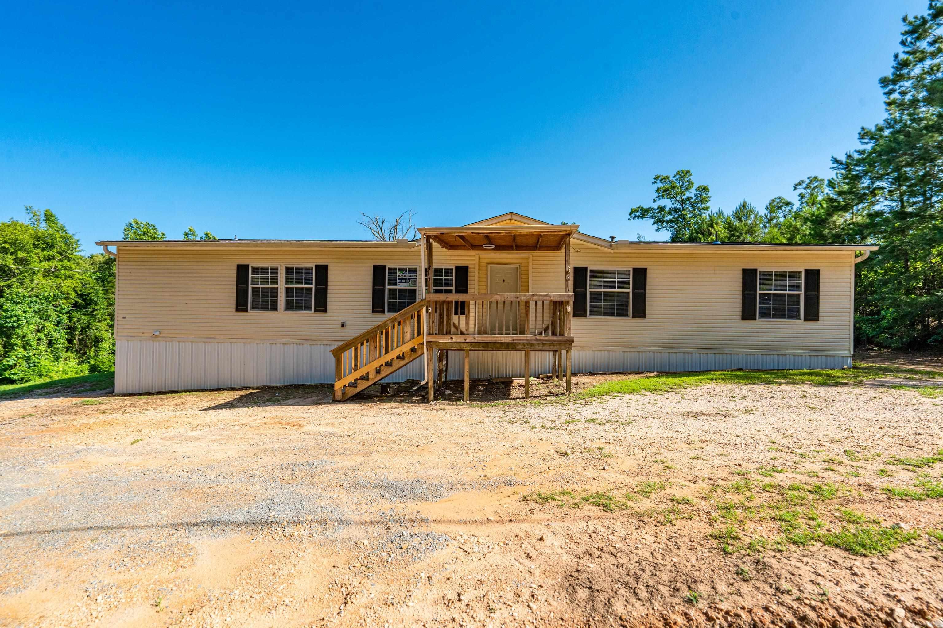 Spacious 5BR/3BA home featuring a split bedroom layout with Jack & Jill bath. Interior includes tile, linoleum, and brand new carpet. Eat-in kitchen with electric stove and pantry. Wood-burning fireplace adds cozy charm to the living area. Primary suite offers a garden tub, separate shower, double vanities, and linen closets. Covered front and back porches provide great outdoor living space. Move-in ready and perfect for a growing family or anyone needing extra room. Jack & Jill bath, Eat-in kitchen, wood-burning fireplace, Electric stove & pantry Covered front & back porches,Garden tub, shower, and double vanities in primary suite,New carpet, tile, and linoleum flooring.