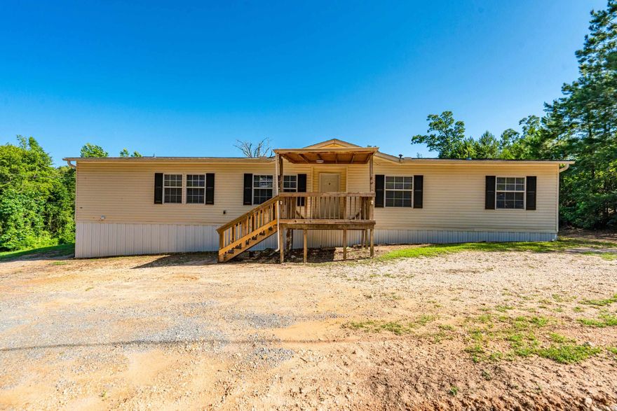 Spacious 5BR/3BA home featuring a split bedroom layout with Jack & Jill bath. Interior includes tile, linoleum, and brand new carpet. Eat-in kitchen with electric stove and pantry. Wood-burning fireplace adds cozy charm to the living area. Primary suite offers a garden tub, separate shower, double vanities, and linen closets. Covered front and back porches provide great outdoor living space. Move-in ready and perfect for a growing family or anyone needing extra room. Jack & Jill bath, Eat-in kitchen, wood-burning fireplace, Electric stove & pantry Covered front & back porches,Garden tub, shower, and double vanities in primary suite,New carpet, tile, and linoleum flooring.