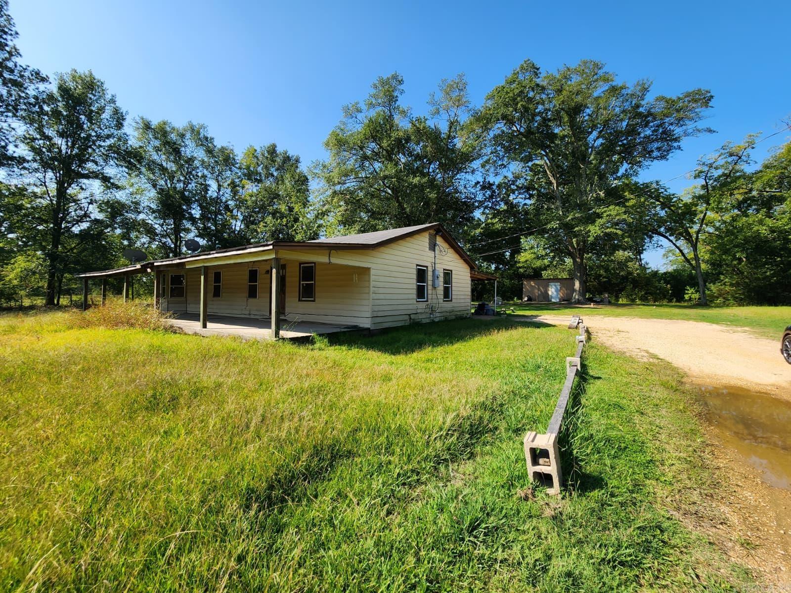 Lots of potential to make this home shine again! Wood floors, spacious bedrooms, large covered outdoor areas. 1.85 acre lot, has been nicely kept with large trees to enjoy. Garden shed. Rear patio could also be used as a carport.
